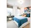Modern bedroom with blue bedding, desk area, and two windows for ample natural light at 8026 Cedarsmith Ct, Charlotte, NC 28217