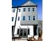 Modern townhome featuring gray and white siding, with a striking multi-story facade and stylish entryway at 8026 Cedarsmith Ct, Charlotte, NC 28217