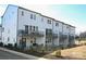 Exterior back view of new townhomes with multiple balconies and outdoor seating areas at 8026 Cedarsmith Ct, Charlotte, NC 28217