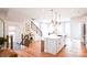 Bright, open kitchen with white cabinets, stainless steel appliances and a large central island at 8026 Cedarsmith Ct, Charlotte, NC 28217