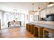 Open concept dining and kitchen area with modern lighting, seating, and stylish decor at 8026 Cedarsmith Ct, Charlotte, NC 28217