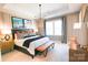 Beautiful primary bedroom featuring a large bed, neutral walls, and a modern chandelier at 8026 Cedarsmith Ct, Charlotte, NC 28217