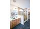 This primary bathroom boasts granite counters, wood tile, and an oversized glass shower at 8034 Cedarsmith Ct, Charlotte, NC 28217
