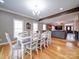 Formal dining area with hardwood floors and large windows with access to kitchen and living room at 8509 Piccone Brook Ln, Charlotte, NC 28216