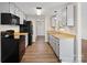 Well-lit kitchen features wood countertops, gray cabinets, and black appliances at 8539 Glenway Ct, Charlotte, NC 28226