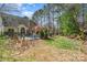 Backyard view featuring a pool, lush greenery and play equipment, perfect for outdoor entertainment at 8704 Dartmoor Pl, Mint Hill, NC 28227