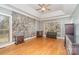 Spacious bedroom with hardwood floors, tray ceiling, and stone accent wall at 8704 Dartmoor Pl, Mint Hill, NC 28227