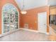 Open dining area bathed in sunlight from a large arched window overlooking the pool at 8704 Dartmoor Pl, Mint Hill, NC 28227