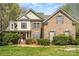 Charming brick home with a welcoming front porch and well-manicured landscaping at 8704 Dartmoor Pl, Mint Hill, NC 28227