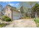 Two-story home with brick and vinyl siding, attached garage, and concrete driveway and basketball hoop at 8704 Dartmoor Pl, Mint Hill, NC 28227