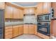 Well-maintained kitchen with light wood cabinets, modern appliances, and ample counter space for food preparation at 8704 Dartmoor Pl, Mint Hill, NC 28227