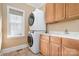 The functional laundry area includes a stacked washer/dryer and built-in cabinetry for added convenience at 8704 Dartmoor Pl, Mint Hill, NC 28227