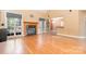 Bright living room with hardwood floors, a fireplace, and large windows offering serene outdoor views at 8704 Dartmoor Pl, Mint Hill, NC 28227