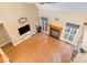 Bright living room with fireplace, hardwood floors, and large windows providing natural light at 8704 Dartmoor Pl, Mint Hill, NC 28227