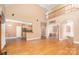 Open-concept living room with hardwood floors and a view of the second-story landing at 8704 Dartmoor Pl, Mint Hill, NC 28227