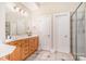 Bright bathroom with double vanity, storage, and glass enclosed shower at 8704 Dartmoor Pl, Mint Hill, NC 28227