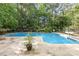 Sparkling in-ground pool surrounded by mature trees offers a private outdoor retreat at 8704 Dartmoor Pl, Mint Hill, NC 28227