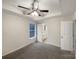 Neutral bedroom with a ceiling fan, bathroom access, and large windows at 89 Fifth St, York, SC 29745