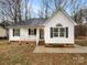 Charming one-story home with white siding, black shutters, covered front porch, and well-maintained landscaping at 89 Fifth St, York, SC 29745