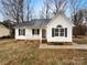 Charming one-story home with white siding, black shutters, covered front porch, and well-maintained landscaping at 89 Fifth St, York, SC 29745
