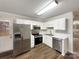 Efficient kitchen featuring stainless steel appliances, white cabinets, and wood-look flooring at 89 Fifth St, York, SC 29745