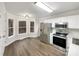 Bright kitchen with stainless steel appliances, wood floors, and large windows at 89 Fifth St, York, SC 29745