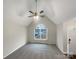 Unfurnished living room with large window, ceiling fan, vaulted ceiling, and neutral gray carpet at 89 Fifth St, York, SC 29745