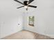 Well-lit bedroom featuring a ceiling fan, window view, and light-toned flooring at 902 Grace St, Kings Mountain, NC 28086