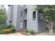 Charming condo exterior with gray siding, mature trees, and tidy landscaping, creating curb appeal at 9035 Jm Keynes Dr # 39, Charlotte, NC 28262