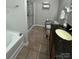 Bathroom featuring a tub, stand up shower, granite vanity and grey walls at 905 Roxburgh Ave, Rock Hill, SC 29732