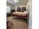 Bedroom with carpet, neutral walls and a vintage white metal bed frame with colorful bedding at 905 Roxburgh Ave, Rock Hill, SC 29732