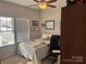 Bedroom featuring neutral walls, carpet, a ceiling fan, and a bed with views of the neighborhood at 905 Roxburgh Ave, Rock Hill, SC 29732