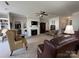 Cozy living room with plush seating, fireplace, neutral walls, and ceiling fan at 905 Roxburgh Ave, Rock Hill, SC 29732