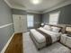 Cozy bedroom with ample natural light, complemented by hardwood floors and neutral decor at 915 Spruce St, Albemarle, NC 28001