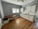Cozy kitchen featuring hardwood floors, white cabinets, and subway tile backsplash at 915 Spruce St, Albemarle, NC 28001