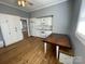 Bright kitchen featuring hardwood floors, white cabinets, and updated appliances at 915 Spruce St, Albemarle, NC 28001
