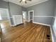 Spacious living room with hardwood floors, neutral wall colors, and white trim at 915 Spruce St, Albemarle, NC 28001