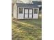 Well-maintained outdoor shed with dark trim and a metal roof in a lush yard at 915 Spruce St, Albemarle, NC 28001