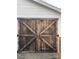 Close up of barn-style wooden shed doors with unique metal hardware at 915 Spruce St, Albemarle, NC 28001