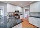 Stylish kitchen with granite countertops, white cabinets and stainless steel sink at 915 Waterview Ln, Monroe, NC 28110