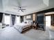 Spacious main bedroom featuring a tray ceiling, a ceiling fan, and dark accent wall at 915 Waterview Ln, Monroe, NC 28110