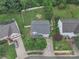 Charming home featuring a well-maintained yard, white picket fence, driveway, and mature trees at 1017 Chalk Hill Ln, Charlotte, NC 28214