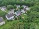 Aerial view of homes nestled among lush trees and landscaping, showing a vibrant neighborhood and community at 1017 Chalk Hill Ln, Charlotte, NC 28214