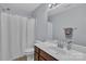 Bathroom featuring a vanity with wood cabinets, sink, toilet and shower with curtain at 1017 Chalk Hill Ln, Charlotte, NC 28214
