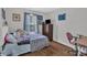 Cozy bedroom with wood floors, dresser and double window at 1017 Chalk Hill Ln, Charlotte, NC 28214