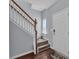 Light foyer entrance featuring carpeted staircase, wood floors and a white front door at 1017 Chalk Hill Ln, Charlotte, NC 28214