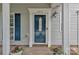 Close-up of front door with decorative details, potted plants and attractive blue shutters at 1017 Chalk Hill Ln, Charlotte, NC 28214