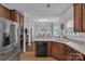 Bright open kitchen with stainless appliances, granite countertops, and connection to dining area at 1017 Chalk Hill Ln, Charlotte, NC 28214