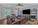 Cozy living room with hardwood floors, a ceiling fan, and ample natural light at 1017 Chalk Hill Ln, Charlotte, NC 28214