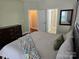 This bedroom features two entryways and a large mirror at 1112 Avalon Pl, Stallings, NC 28104